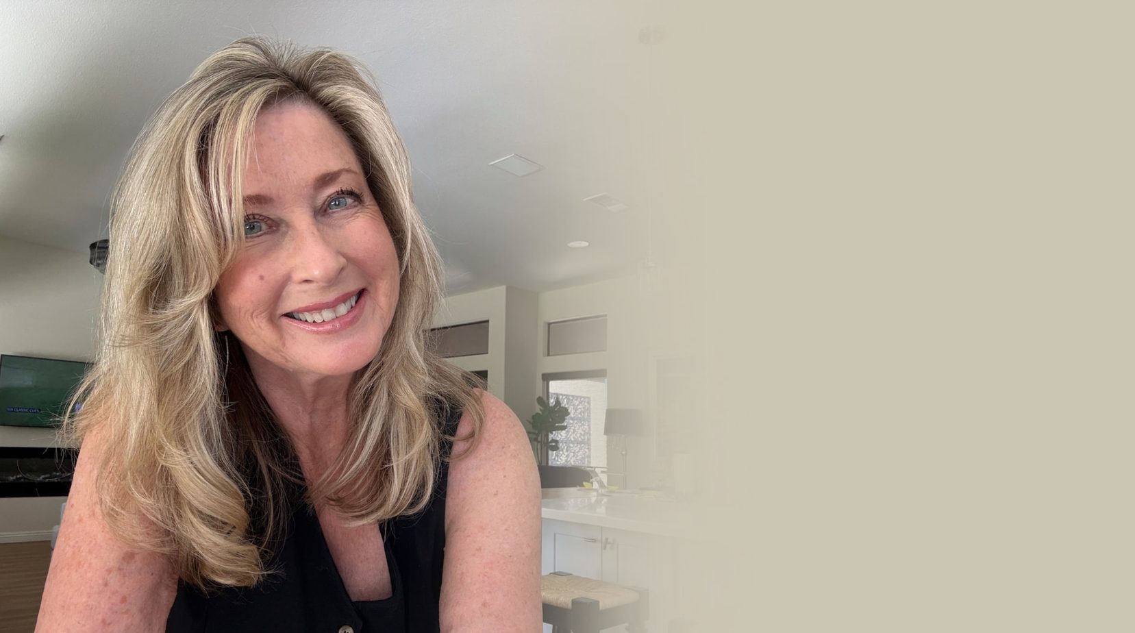 Lisa Redman smiling in her sunlit living room at home in Las Vegas
